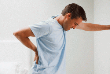 Man holding his low back because of back pain